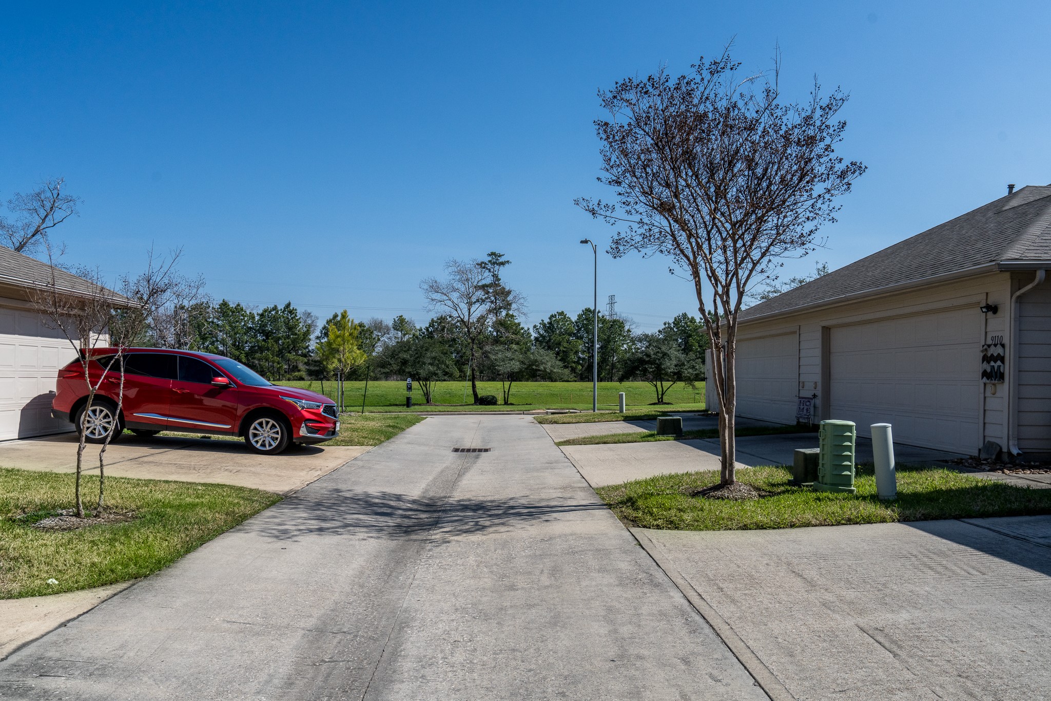 9115 Monarch Mist Lane Houston, TX 77070 - Photo 25 of 26 a yellow house with trees in front of it
