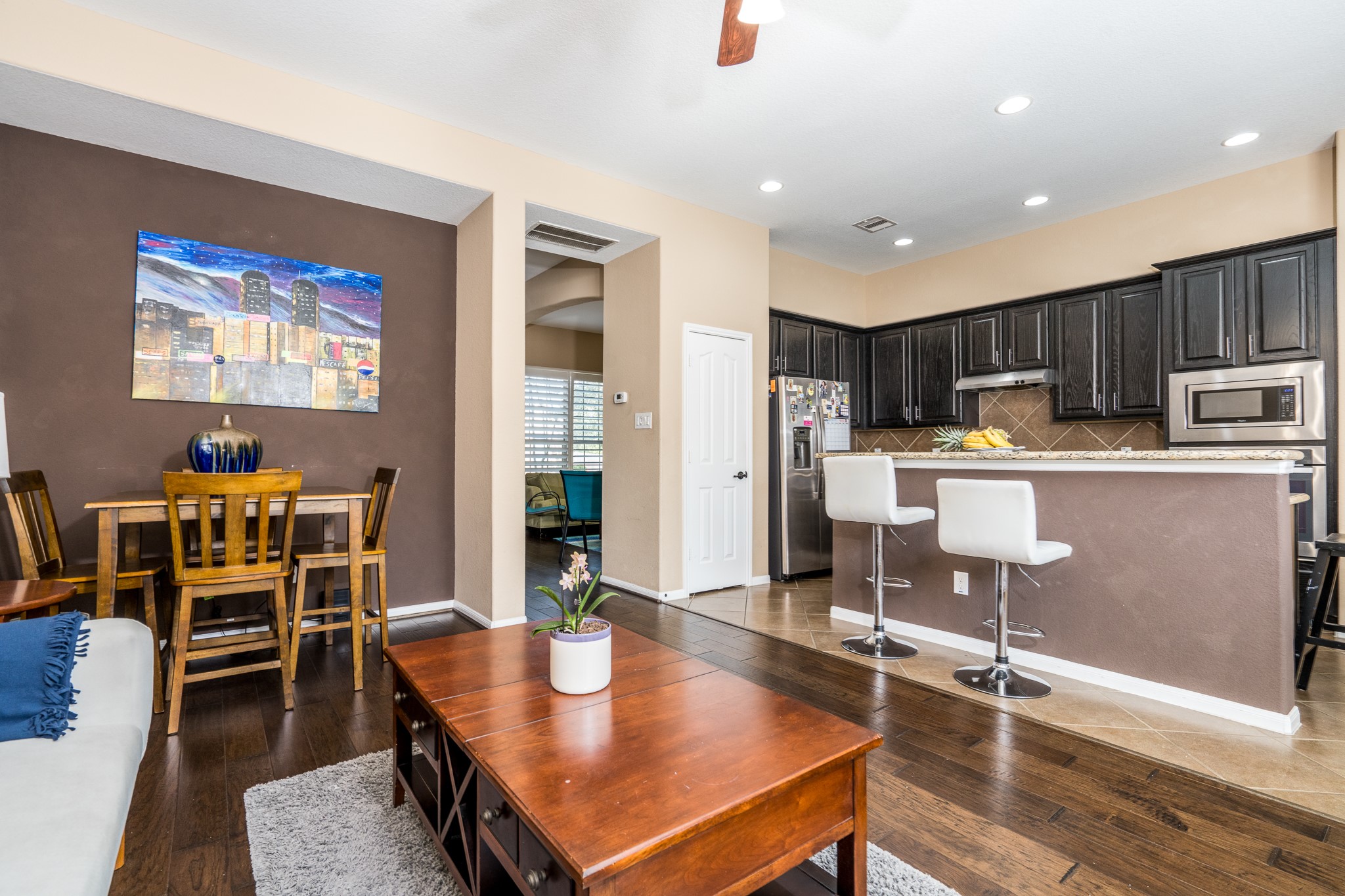 9115 Monarch Mist Lane Houston, TX 77070 - Photo 9 of 26 a living room with stainless steel appliances furniture a dining table with kitchen view