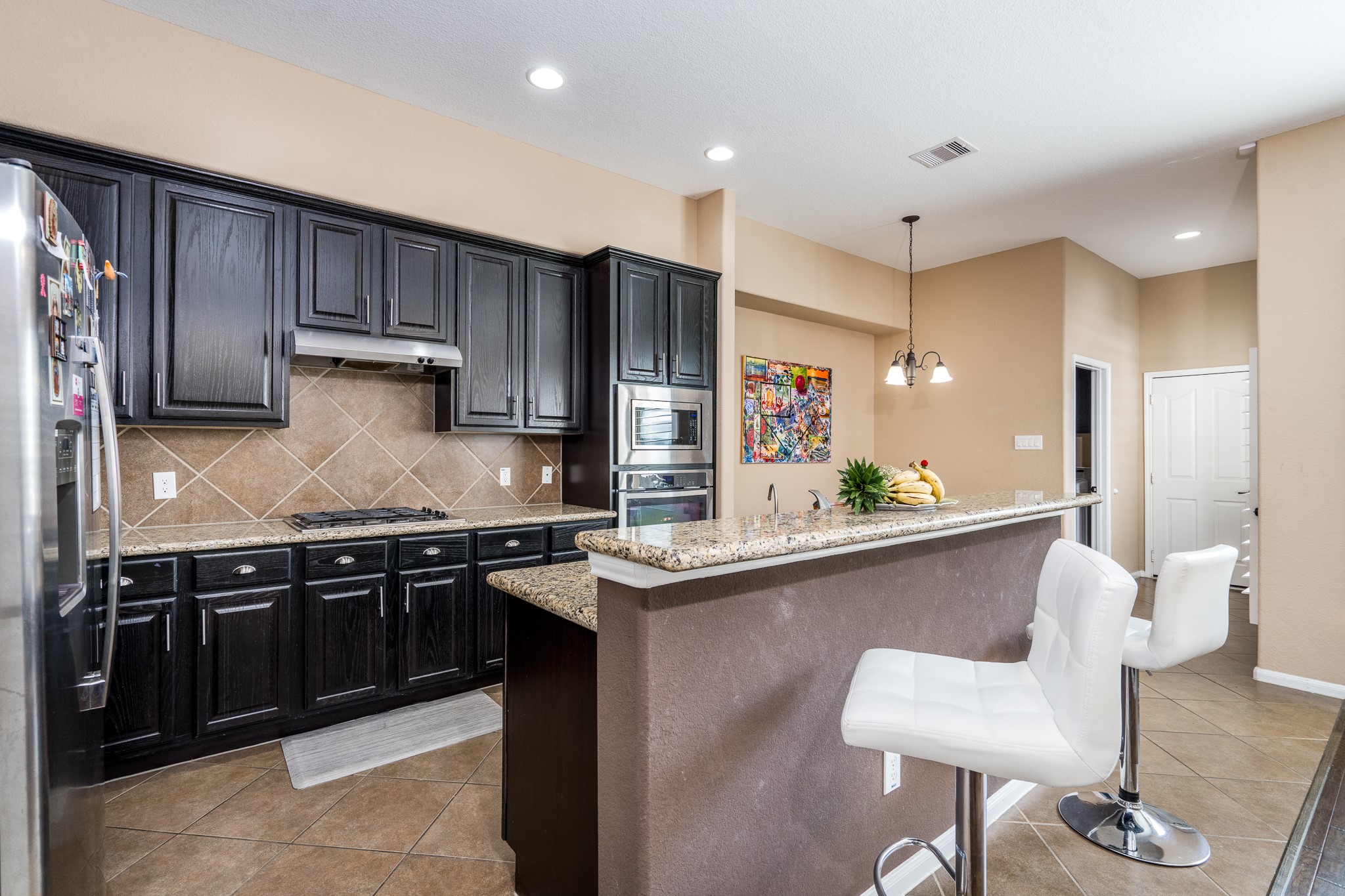 9115 Monarch Mist Lane Houston, TX 77070 - Photo 10 of 26 a kitchen with stainless steel appliances granite countertop a sink and stove