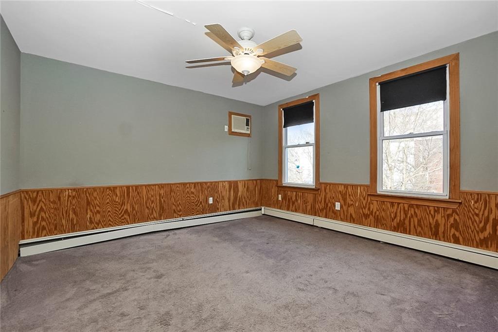 43 Reeve Place Brooklyn, NY 11218 - Photo 11 of 18 an empty room with chandelier fan and windows