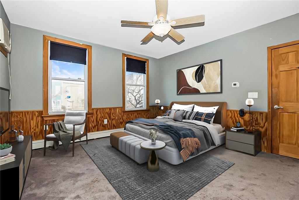 43 Reeve Place Brooklyn, NY 11218 - Photo 12 of 18 a spacious bedroom with a bed a couch and a chandelier