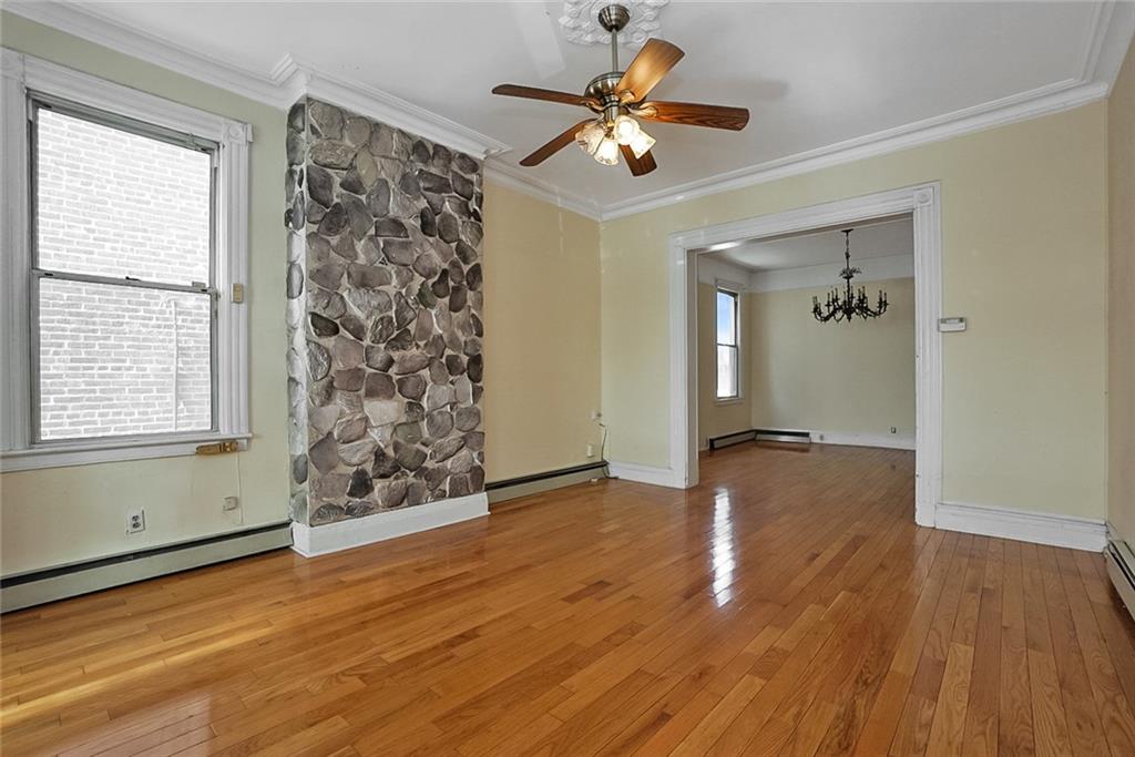 43 Reeve Place Brooklyn, NY 11218 - Photo 7 of 18 wooden floor in an empty room with a window