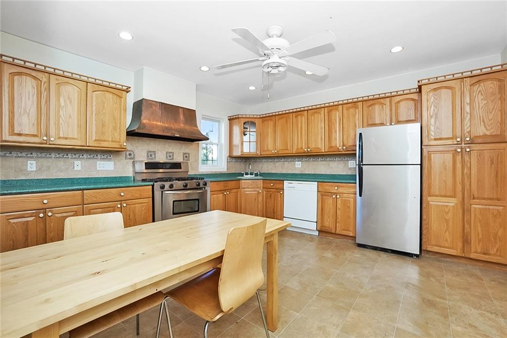 43 Reeve Place Brooklyn, NY 11218 - Photo 10 of 18 a kitchen with stainless steel appliances granite countertop a refrigerator sink stove microwave and cabinets