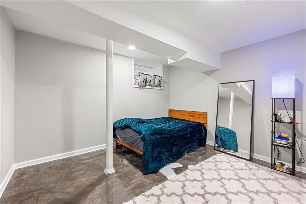 653 Somerset Terrace Northeast, Unit 3 Atlanta, GA 30306 - Photo 12 of 16 a living room with a couch and a bookshelf