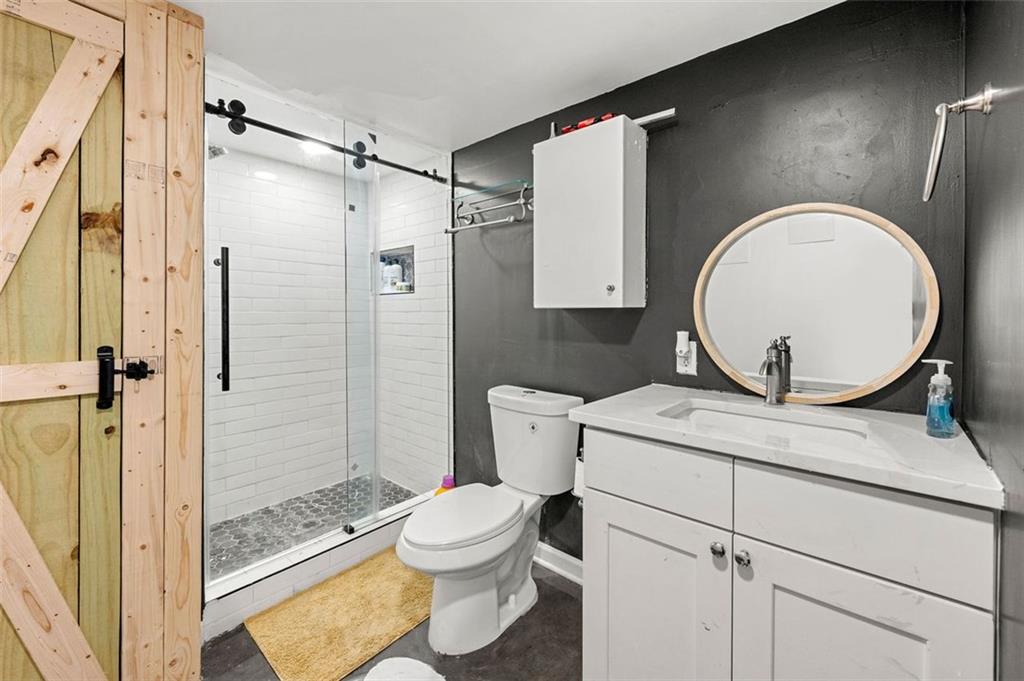 653 Somerset Terrace Northeast, Unit 3 Atlanta, GA 30306 - Photo 14 of 16 a bathroom with a sink toilet and shower