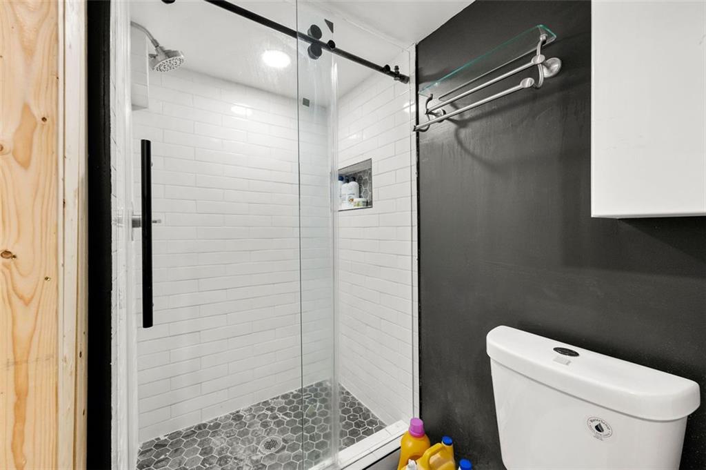 653 Somerset Terrace Northeast, Unit 3 Atlanta, GA 30306 - Photo 15 of 16 a bathroom with a toilet and a shower