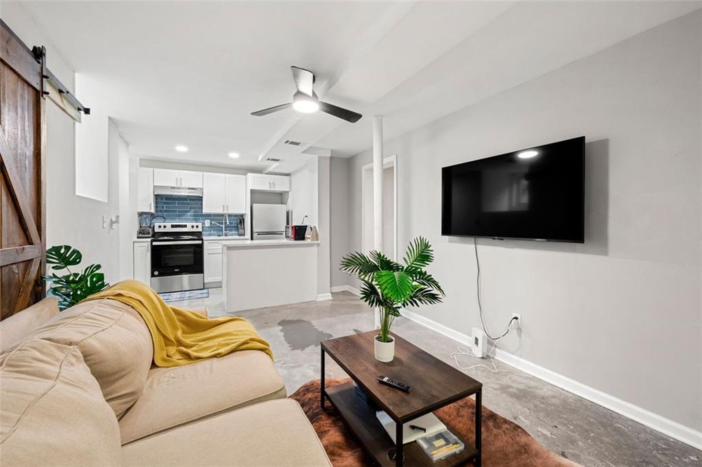 653 Somerset Terrace Northeast, Unit 3 Atlanta, GA 30306 - Photo 3 of 16 a living room with furniture a flat screen tv and a fireplace