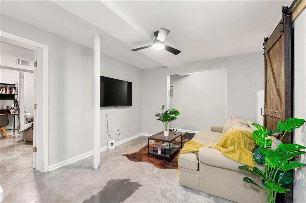 653 Somerset Terrace Northeast, Unit 3 Atlanta, GA 30306 - Photo 6 of 16 a living room with furniture and a flat screen tv