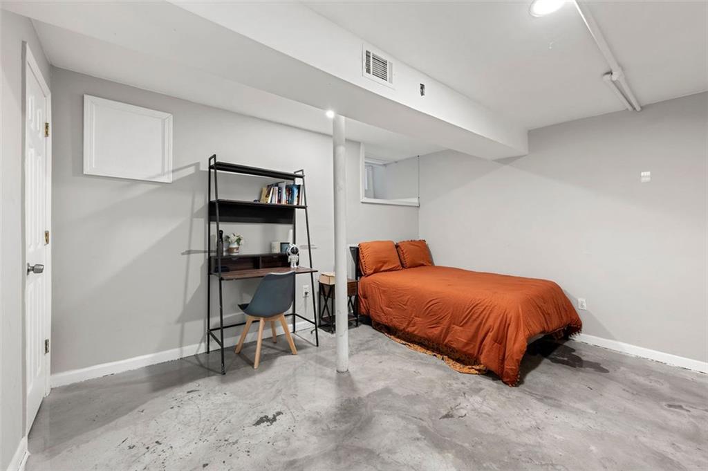 653 Somerset Terrace Northeast, Unit 3 Atlanta, GA 30306 - Photo 8 of 16 a bedroom with a bed and a chair in it