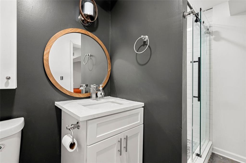 653 Somerset Terrace Northeast, Unit 3 Atlanta, GA 30306 - Photo 10 of 16 a bathroom with a sink a toilet and a mirror