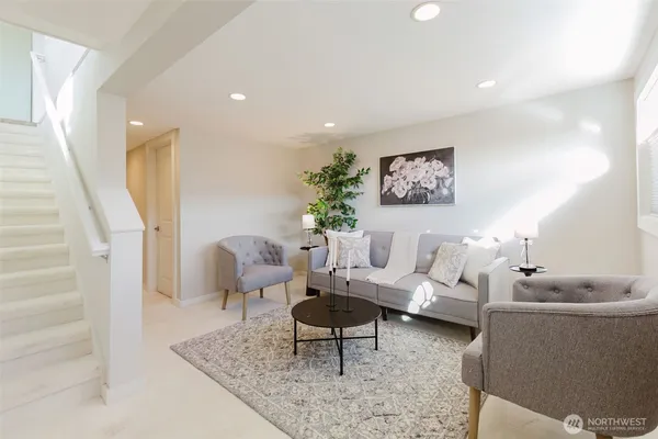 a living room with furniture and a potted plant