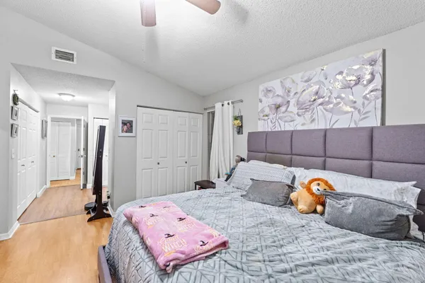 a bedroom with a bed and a painting on the wall