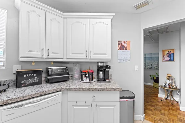 a kitchen with stainless steel appliances granite countertop a sink and cabinets
