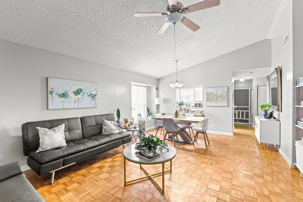 a living room with furniture and a chandelier