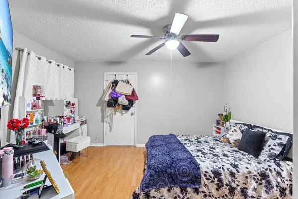 a bedroom with a bed and a chandelier