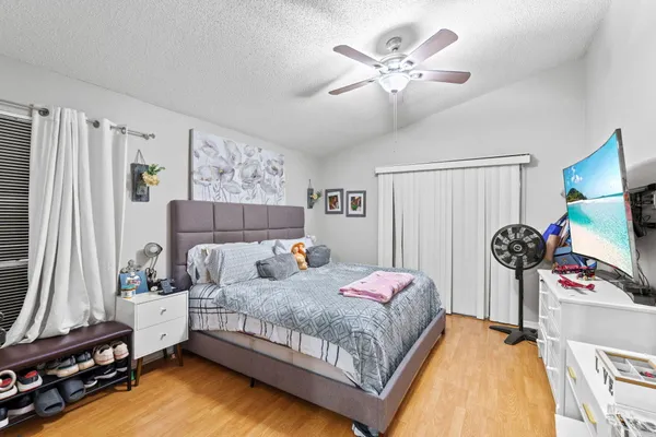 a bedroom with a bed and a chandelier