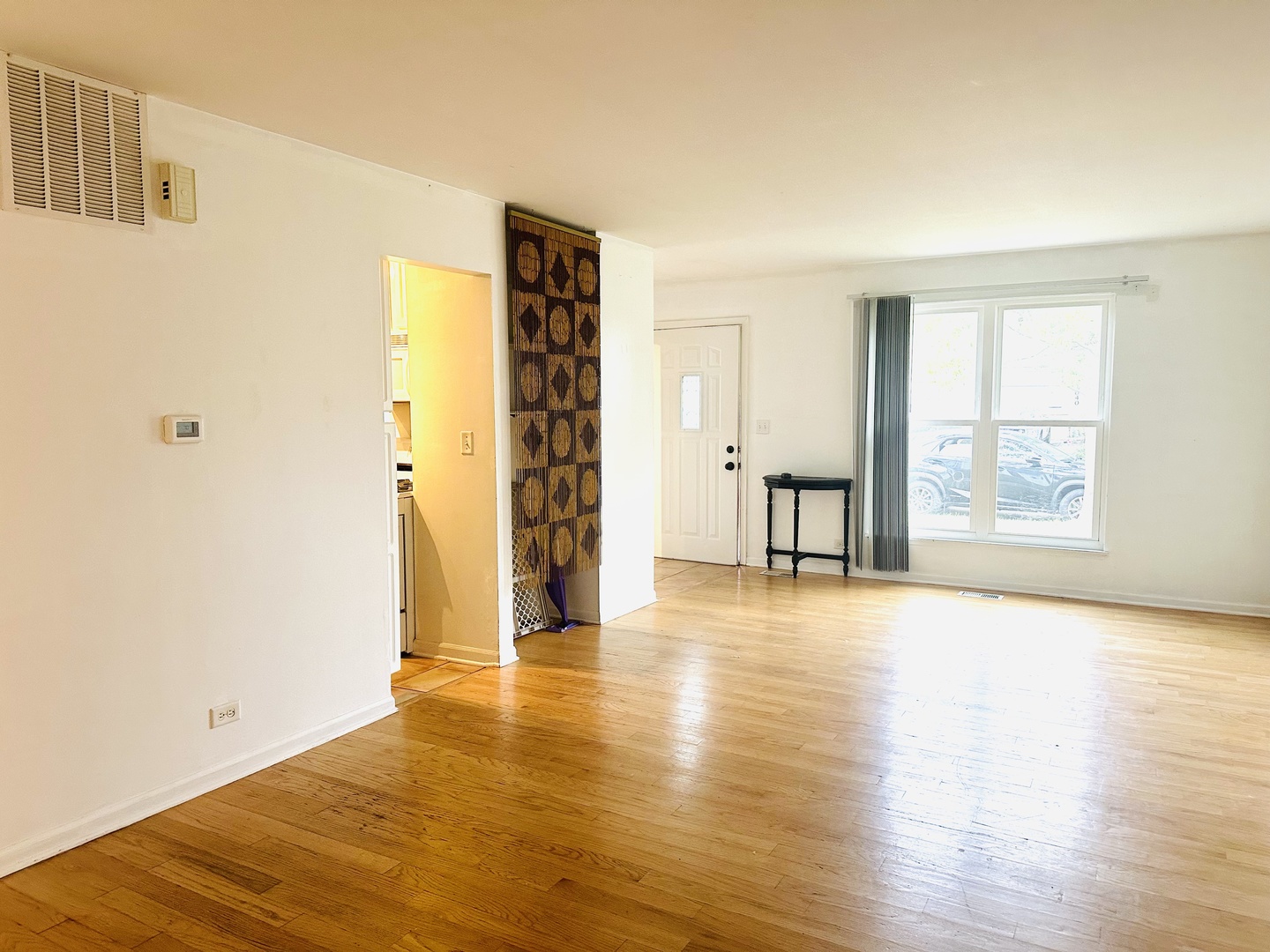 1021 Perry Drive Algonquin, IL 60102 - Photo 5 of 9 a view of an empty room with wooden floor and a window