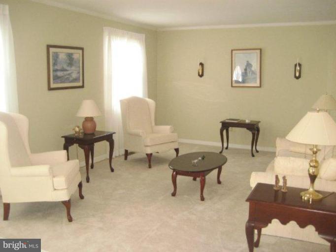 3725 Briars Road Olney, MD 20832 - Photo 5 of 12 a living room with furniture and a lamp