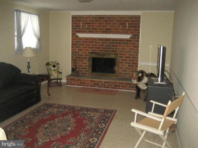 3725 Briars Road Olney, MD 20832 - Photo 6 of 12 a living room with furniture windows and a fireplace