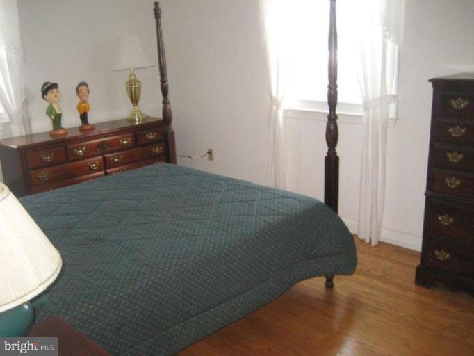 3725 Briars Road Olney, MD 20832 - Photo 9 of 12 a bedroom with a bed and a dresser