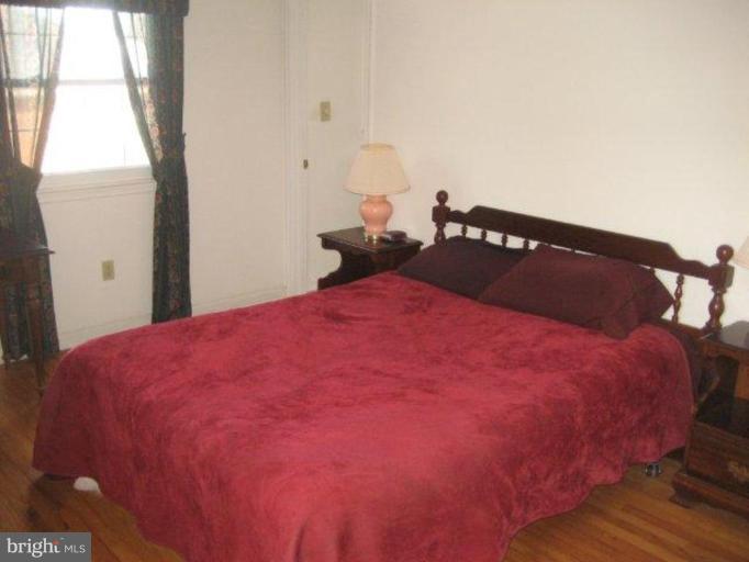 3725 Briars Road Olney, MD 20832 - Photo 10 of 12 a bed sitting in a bedroom next to a window