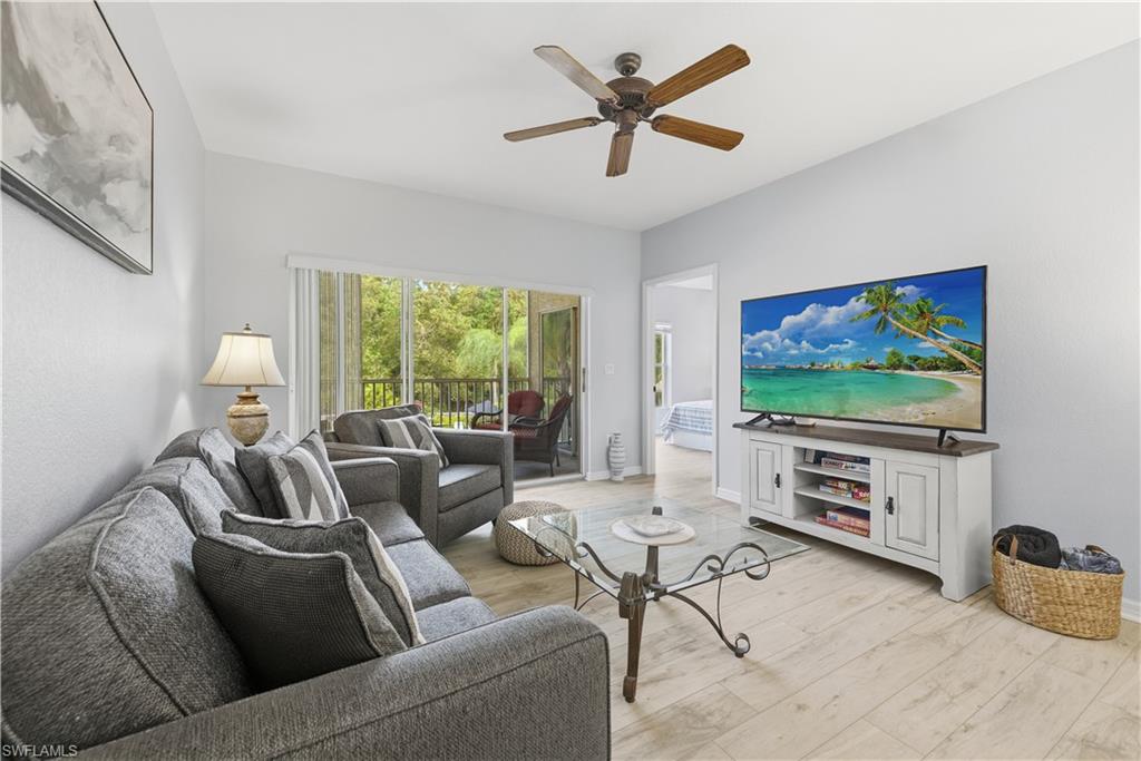 9175 Celeste Drive, Unit 204 Naples, FL 34113 - Photo 20 of 50 Large flat screen television and view of the preserve area