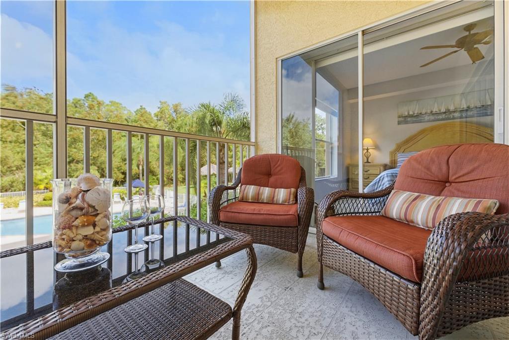 9175 Celeste Drive, Unit 204 Naples, FL 34113 - Photo 31 of 50 "Wine down" on the lanai, and enjoy the pool and spa view, with swaying palms