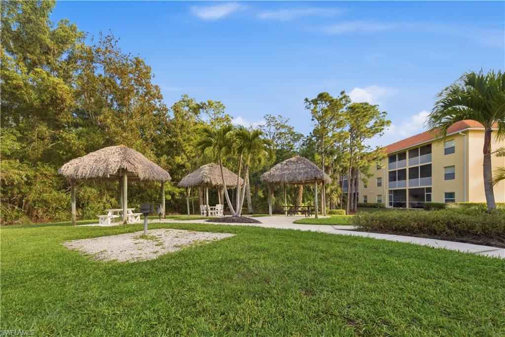 9175 Celeste Drive, Unit 204 Naples, FL 34113 - Photo 38 of 50 Party fun in the tiki huts and grilling areas with tables
