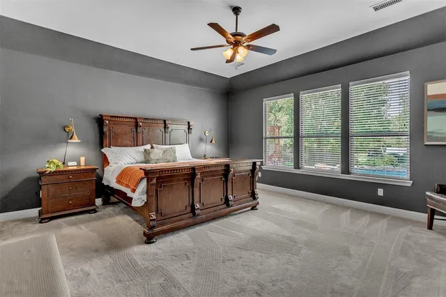 a bedroom with a bed and a large window