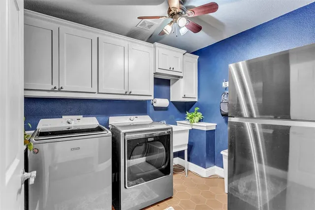 a kitchen with a stove a refrigerator and cabinets