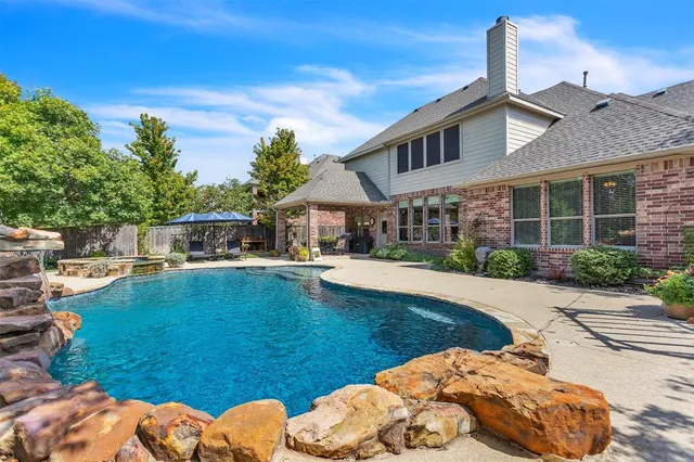 a front view of a house with swimming pool having outdoor seating