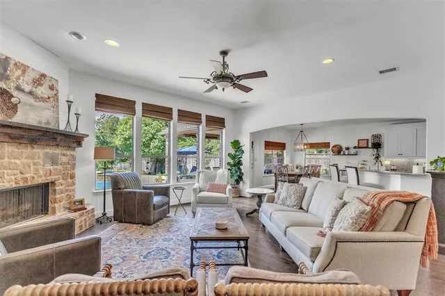 a living room with furniture fireplace and a large window