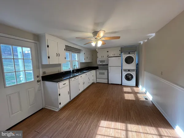 a kitchen with stainless steel appliances a stove a sink and a microwave