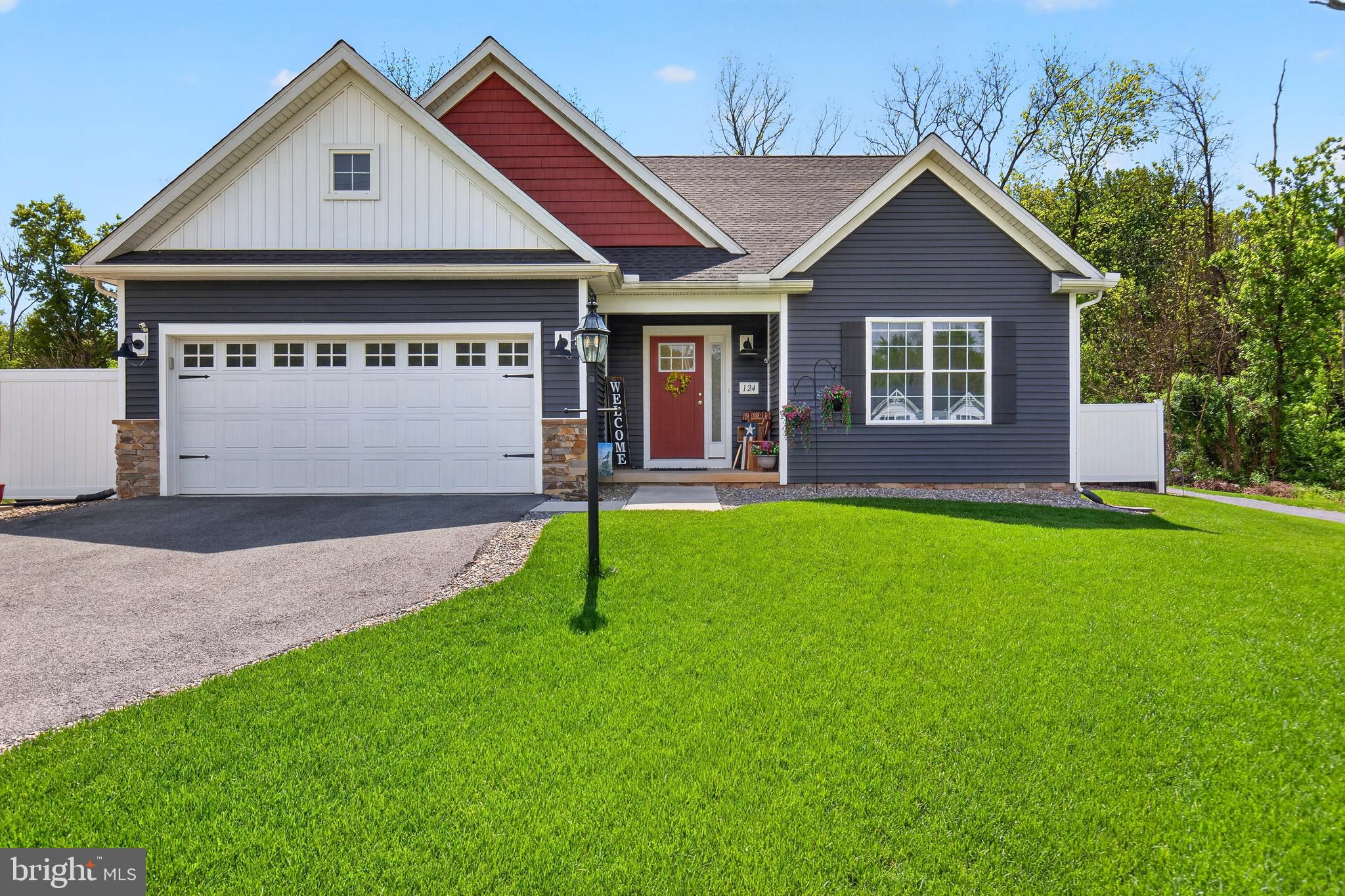 a front view of a house with a garden and yard