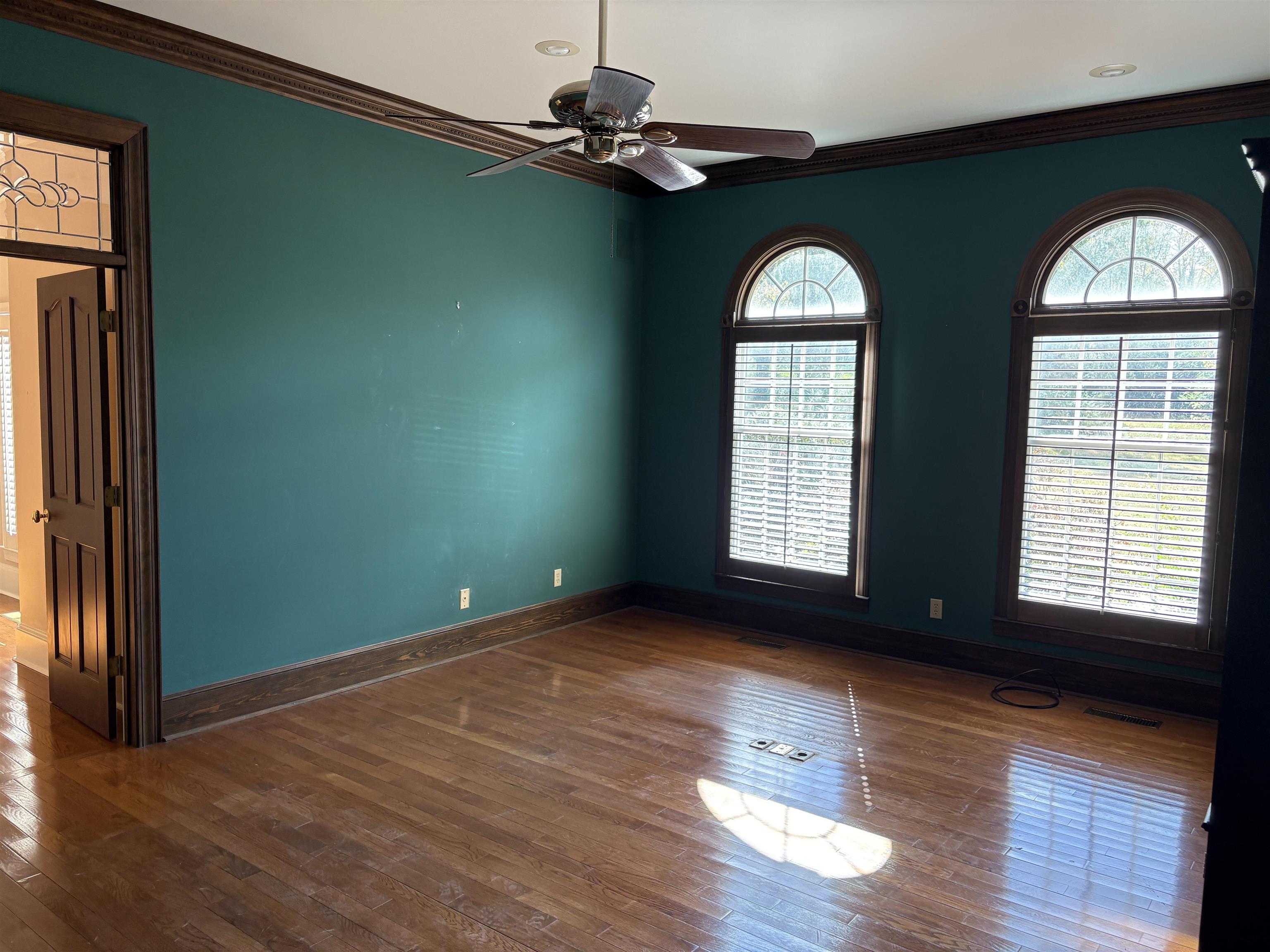 1200 Sand Ridge Bargerton Road Lexington, TN 38351 - Photo 2 of 40 an empty room with wooden floor windows and outdoor view