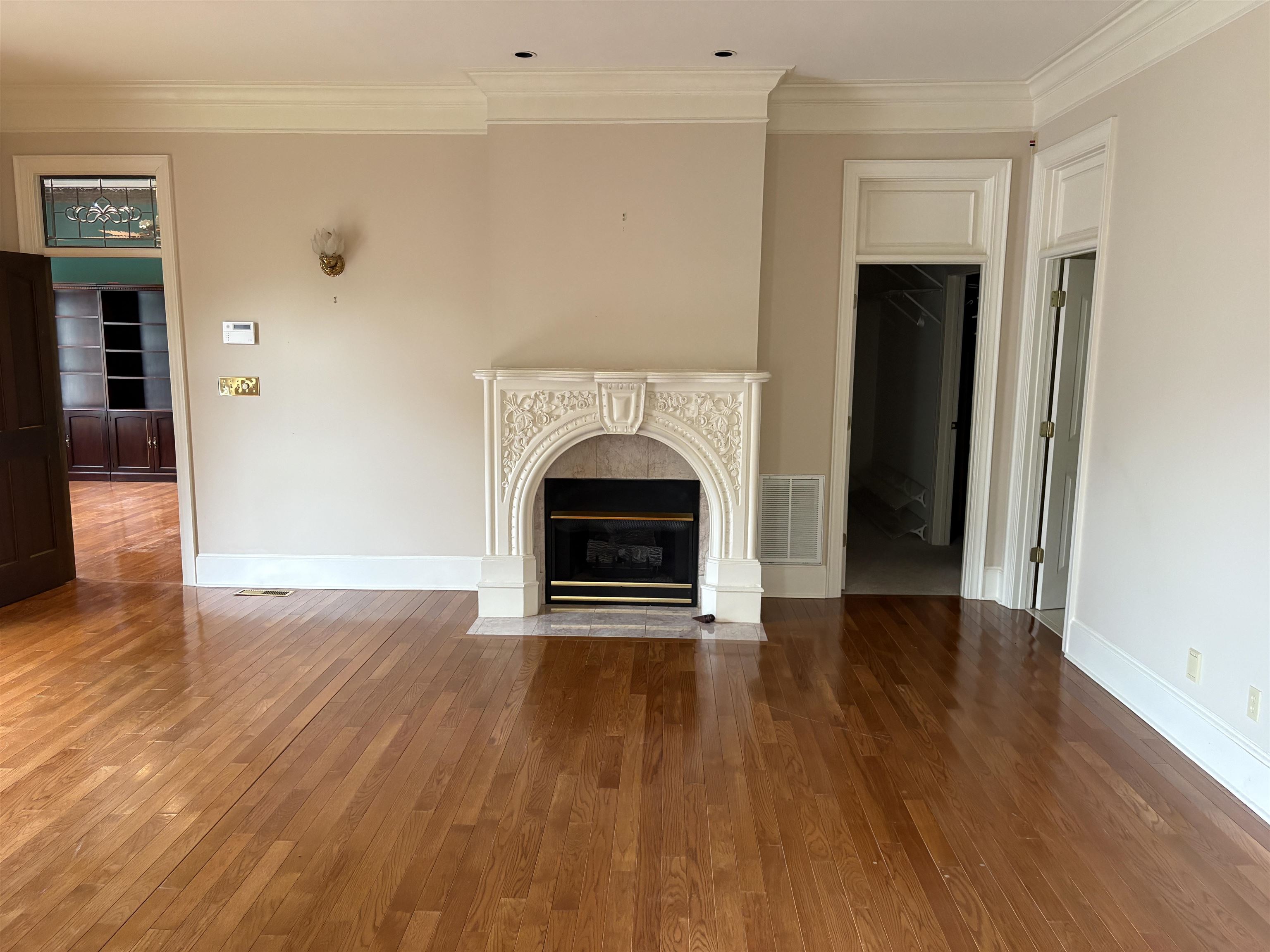 1200 Sand Ridge Bargerton Road Lexington, TN 38351 - Photo 6 of 40 a view of an empty room with wooden floor fireplace and a window