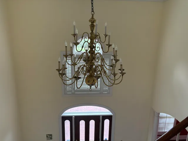 a view of an empty room with wooden floor and a fireplace