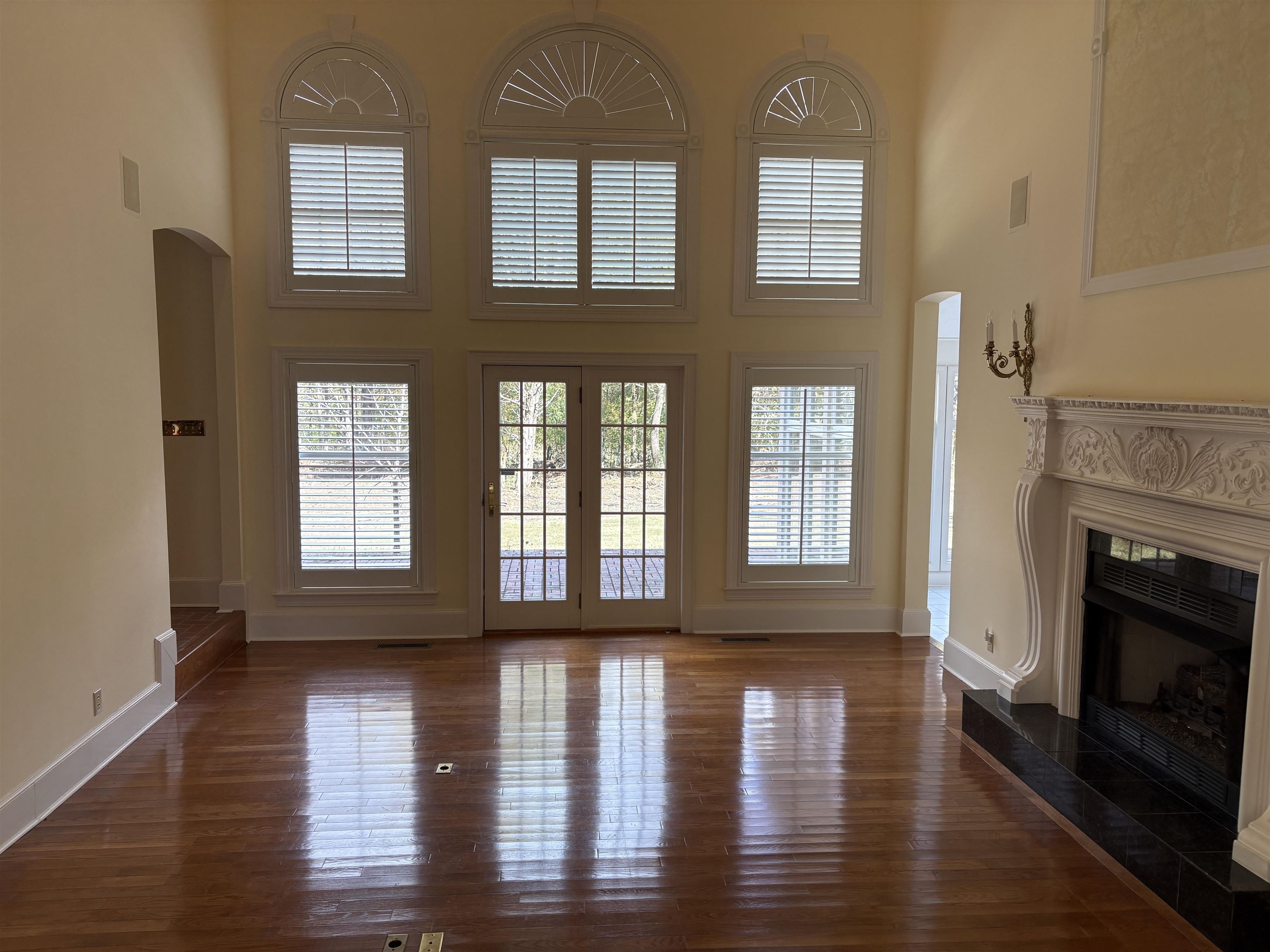 1200 Sand Ridge Bargerton Road Lexington, TN 38351 - Photo 9 of 40 a view of an empty room with wooden floor and a fireplace