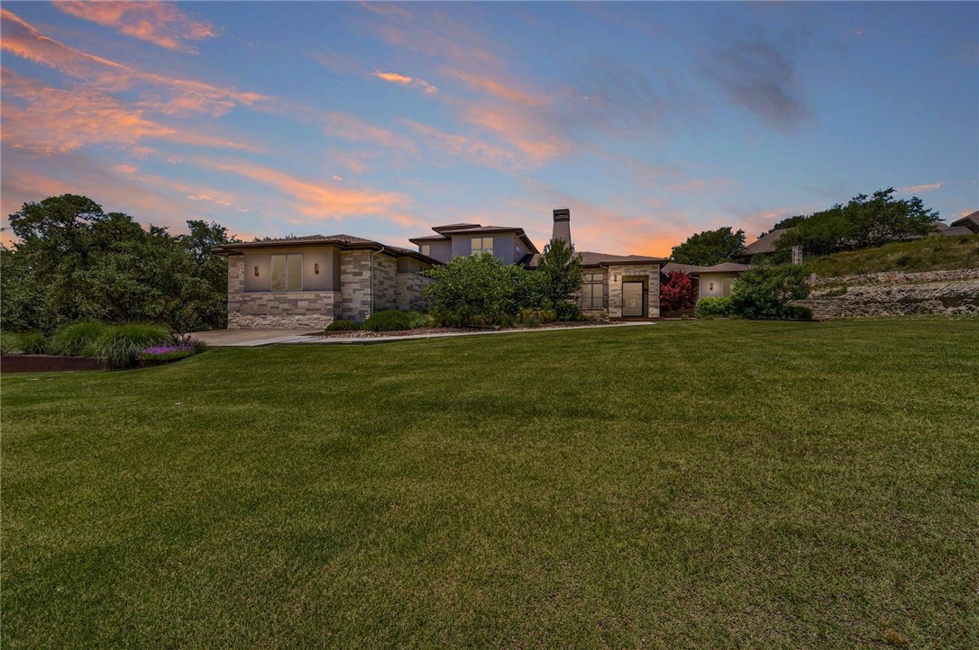 919 Drifting Wind Run Dripping Springs, TX 78620 - Photo 1 of 1 a view of a big yard with plants and a large tree