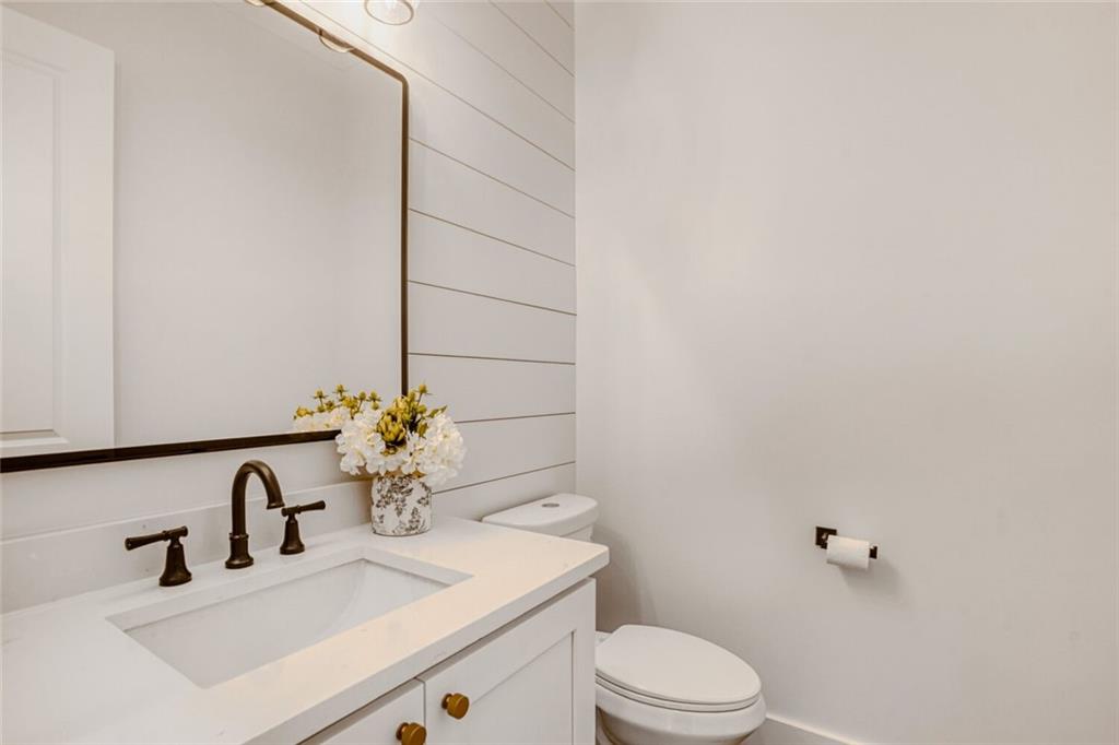 932 Cooper Road Loganville, GA 30052 - Photo 17 of 36 a bathroom with a sink vanity mirror and toilet