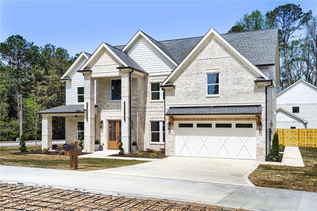 932 Cooper Road Loganville, GA 30052 - Photo 2 of 36 a view of a white house with large windows and a table and chairs