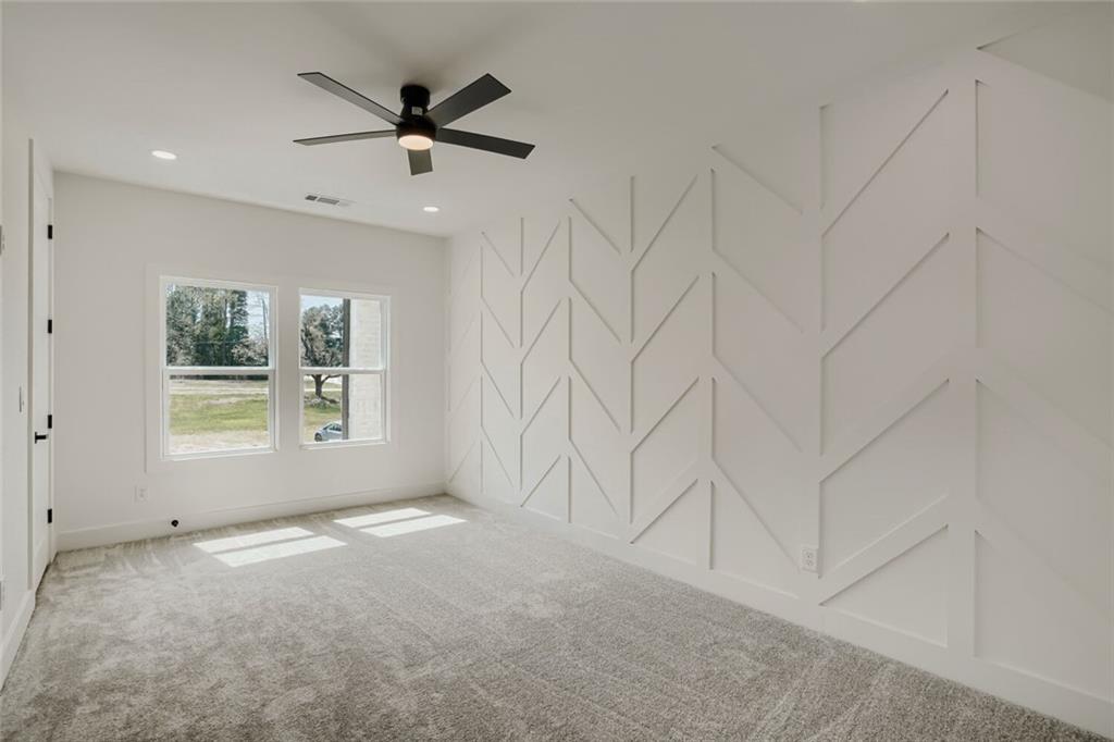 932 Cooper Road Loganville, GA 30052 - Photo 23 of 36 a view of a livingroom with a ceiling fan and window