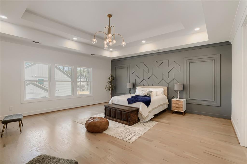 932 Cooper Road Loganville, GA 30052 - Photo 29 of 36 a spacious bedroom with a bed and window