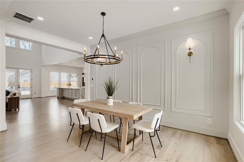932 Cooper Road Loganville, GA 30052 - Photo 8 of 36 a view of a dining room with furniture wooden floor and chandelier