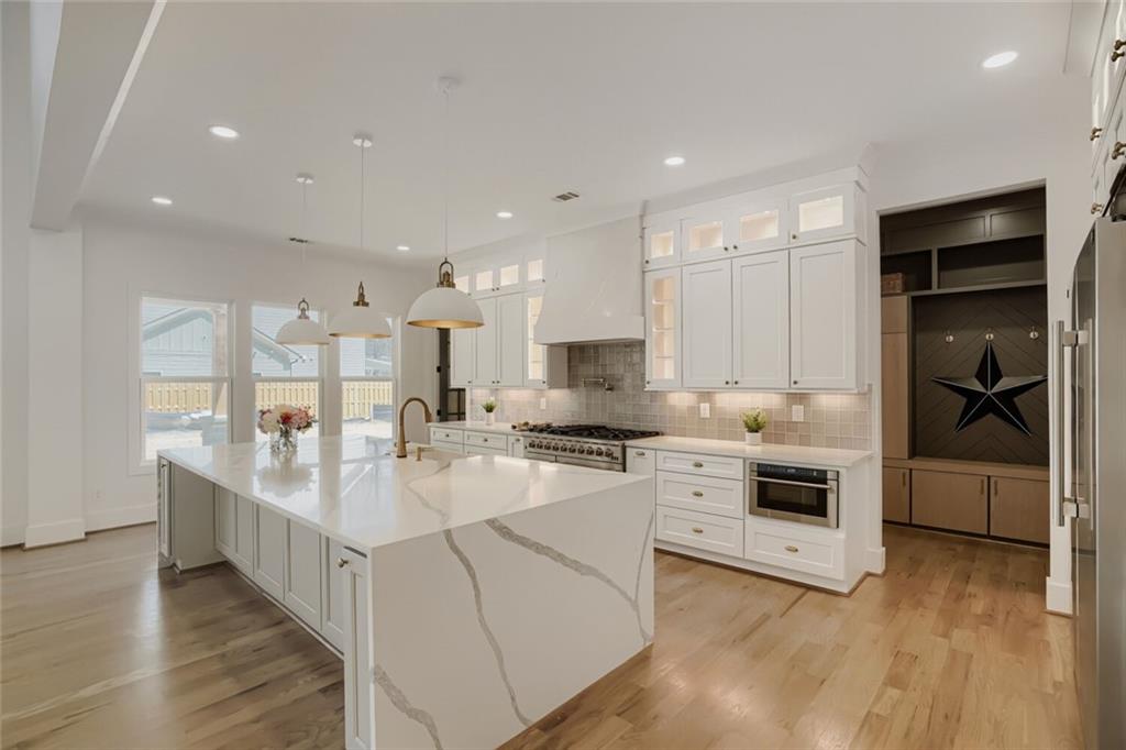 932 Cooper Road Loganville, GA 30052 - Photo 10 of 36 a large white kitchen with a stove top oven
