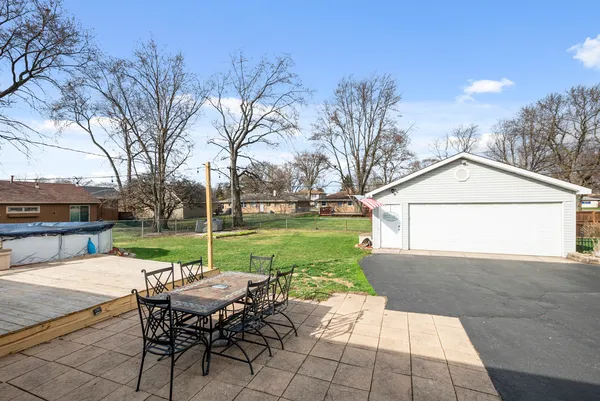 a view of a house with a big yard and large trees
