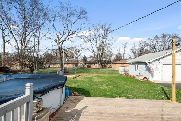 a view of a house with backyard and a sitting area