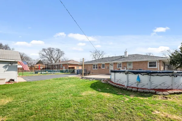 an aerial view of house with yard swimming pool and outdoor seating
