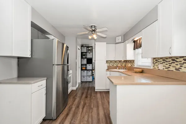 a kitchen with granite countertop a sink cabinets and window