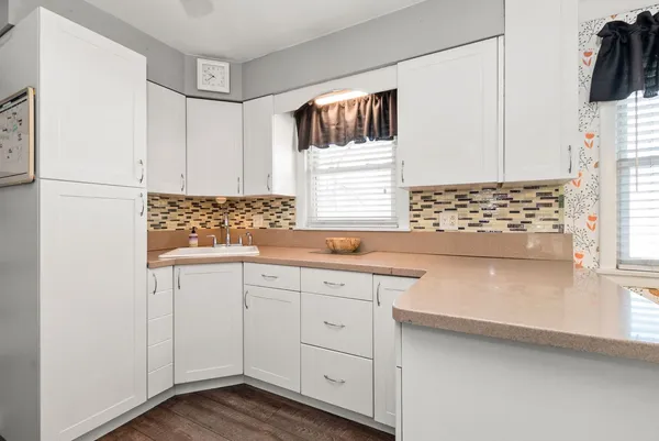 a white refrigerator freezer and a stove sitting inside of a kitchen